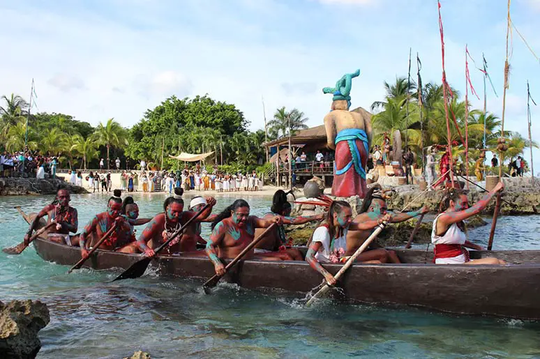 Image showing the segment of the Mayan reenactment of Sacred Mayan Crossing as the canoeists paddle out of Chankanaab Beach Park in Cozumel starting their return journey to Xcaret in Playa del Carmen.