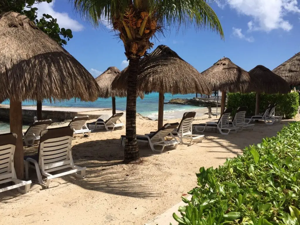 Lounge chairs and palapa umbrellas at a Cozumel Beach club in the northern shore of the island.