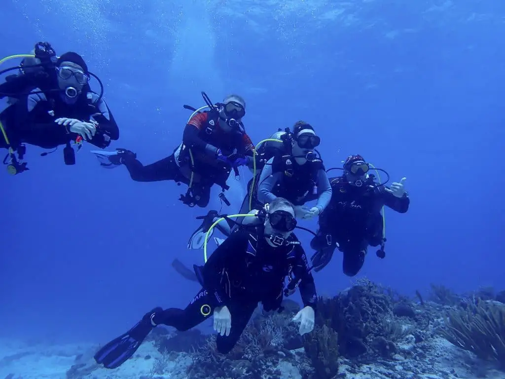 Divers in March with full length wetsuits in Cozumel, Mexico.
