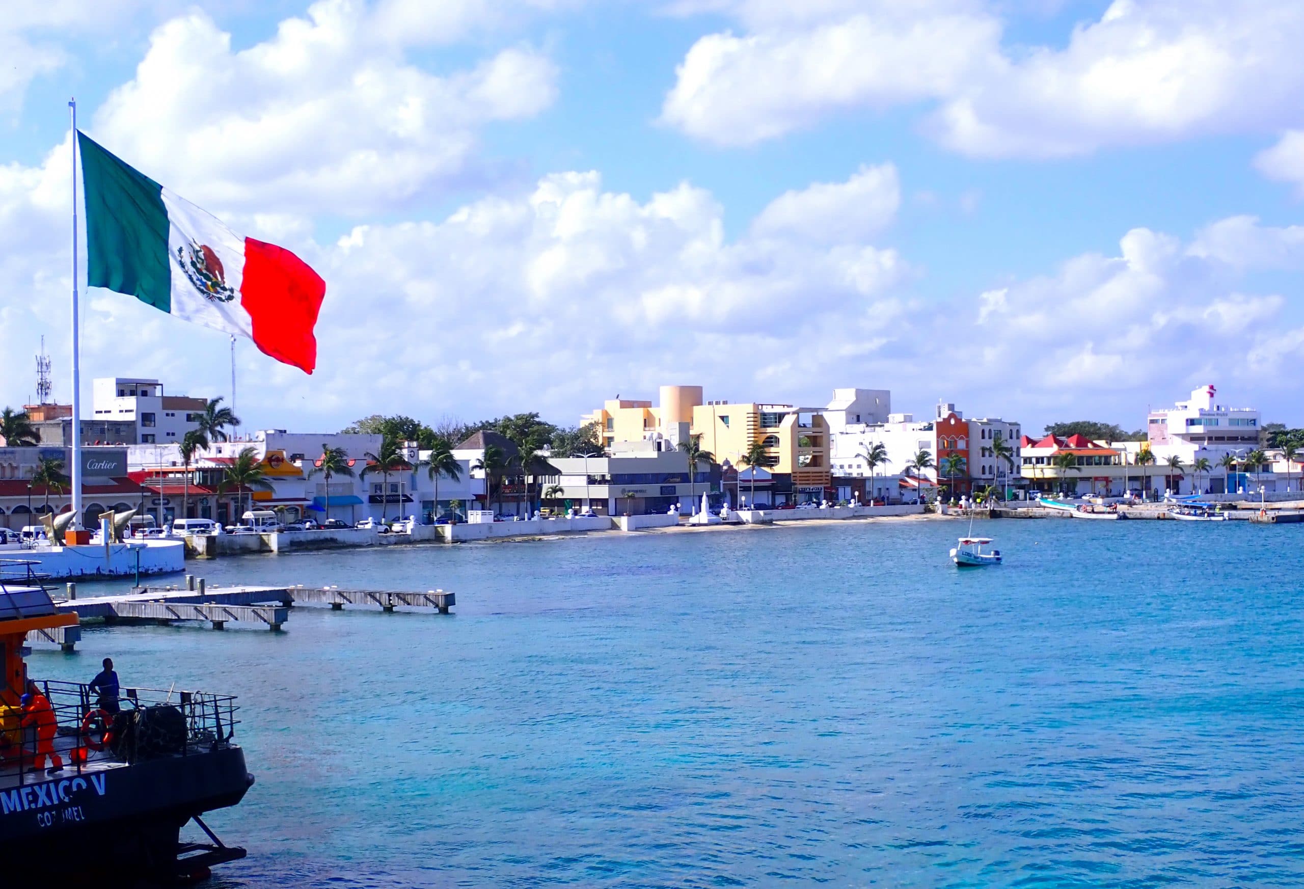 Pretty view of downtown Cozumel from blue water looking toward shoreline buildings