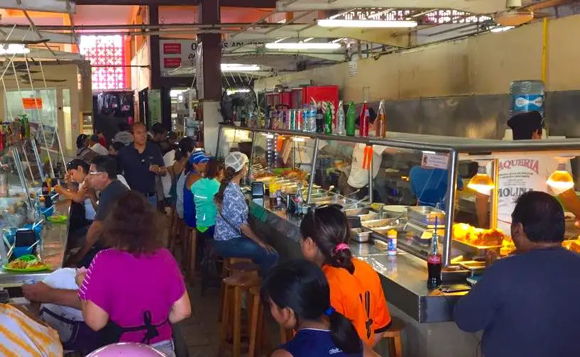 Busy taqueria lunch counter in Cozumel's municipal market.