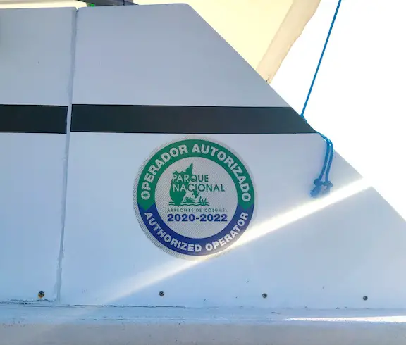 Decal on Cozumel dive boat indicating it's an authorized tourism operator