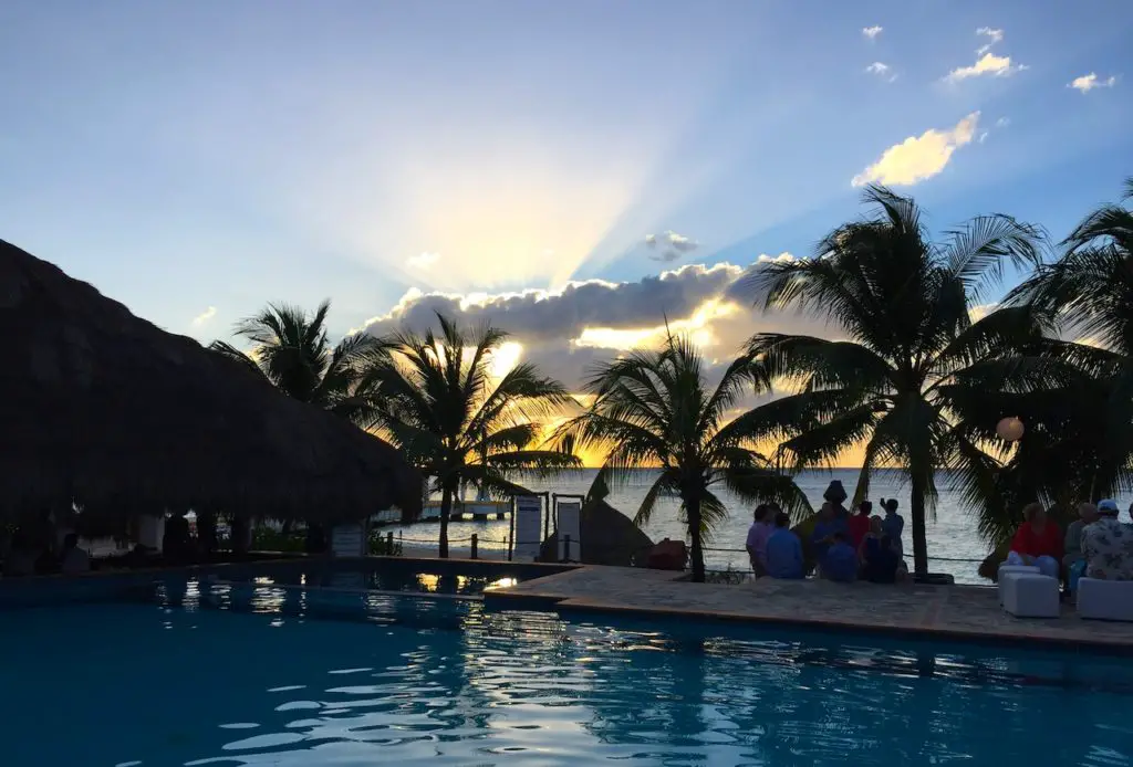 Sunset picture over pool reflection and ocean beach front at Nachi Cocom Beach Club in Cozumel