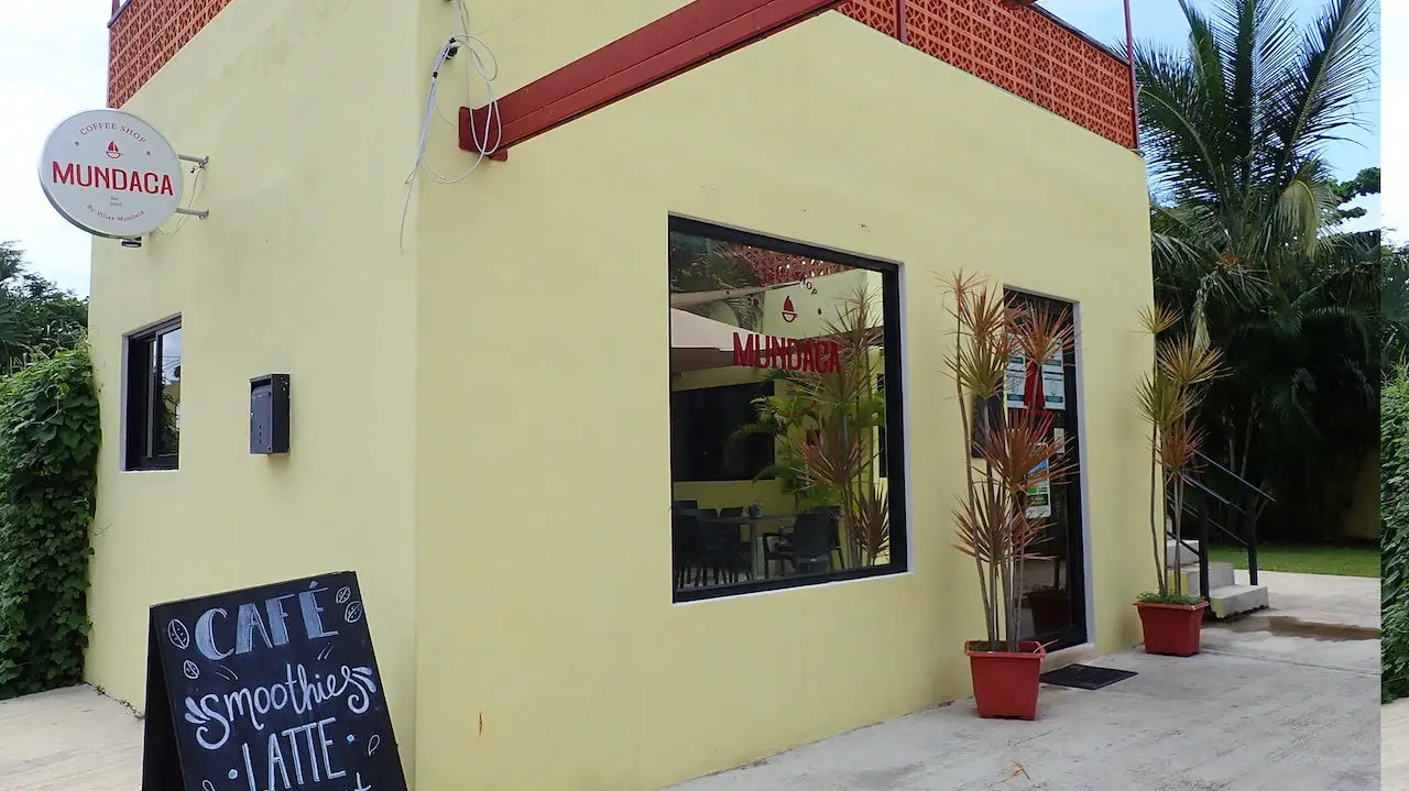 Mundaca coffee cafe in Cozumel, Mexico, showing yellow facade adn exterior view.