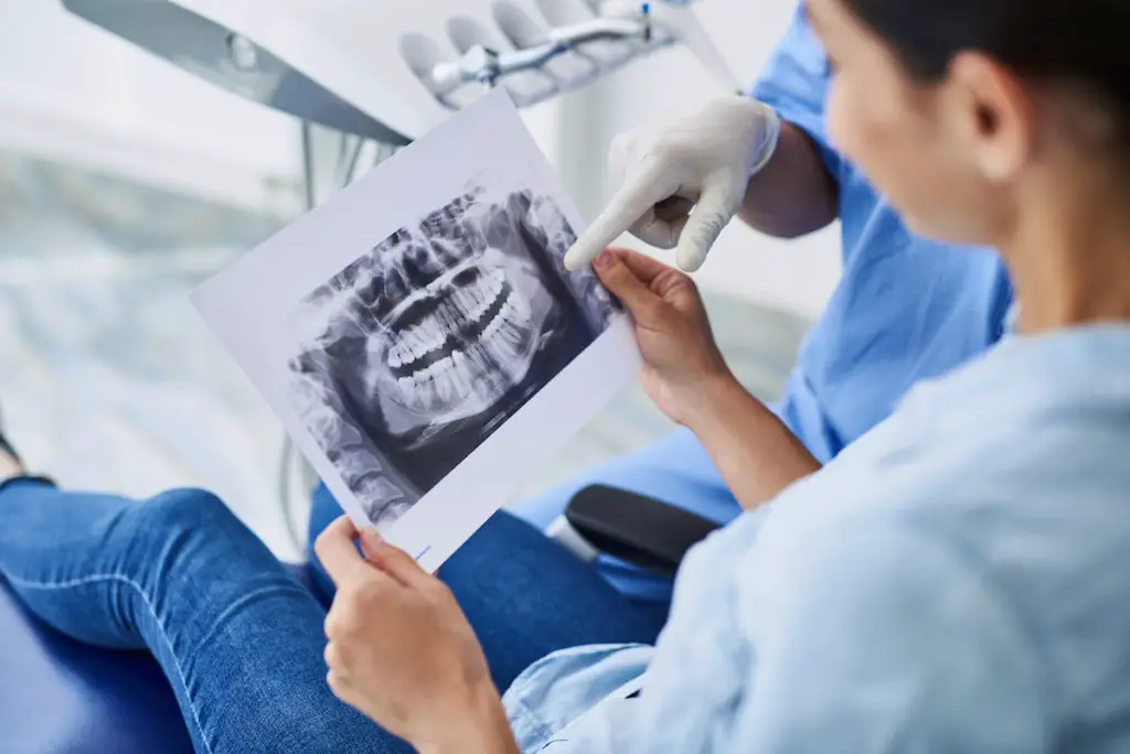 Dental patient looking at oral x-rays with Dentist.