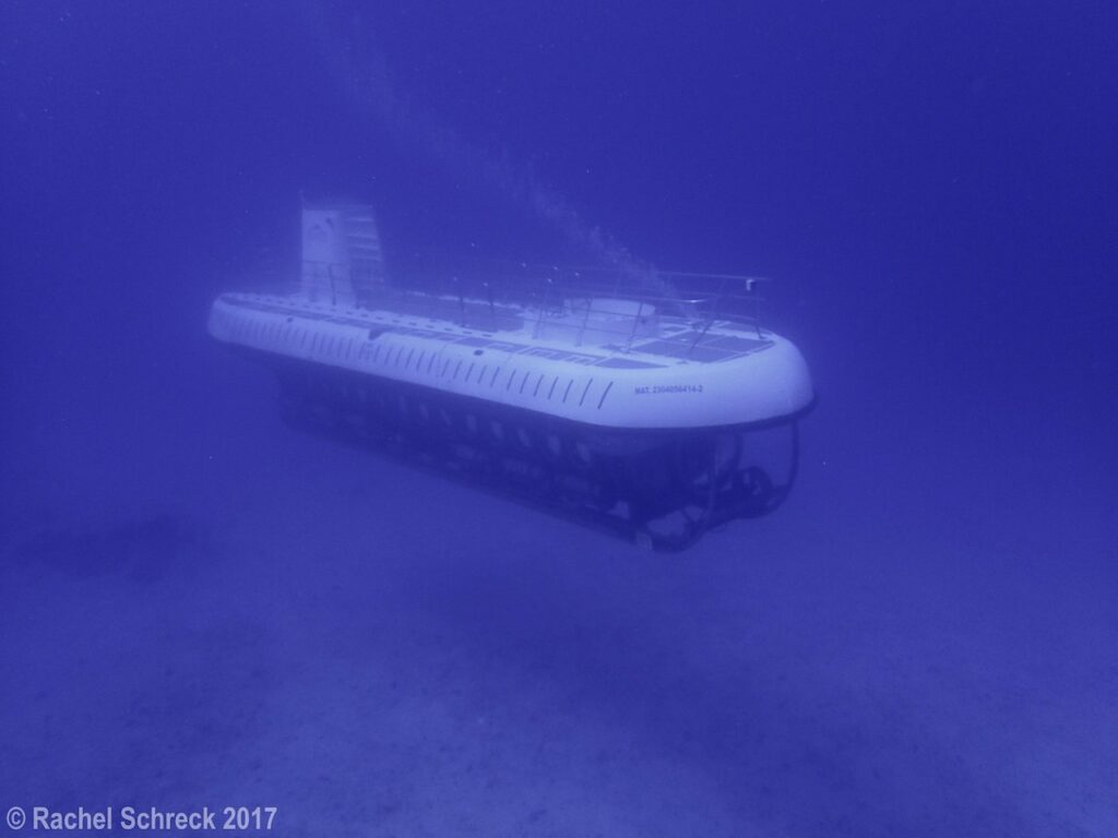 Underwater image of the Atlantis Submarine ride as it passes by divers on the C-53 wreck in Cozumel