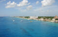 Aerial view of Cozumel's Western Coasline with large hotels and bright blue ocean water.