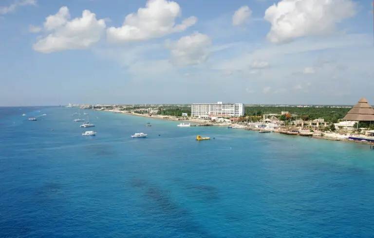 Aerial view of Cozumel's Western Coasline with large hotels and bright blue ocean water.