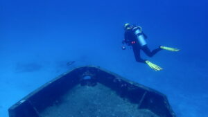 Diver hovering over bow of the Cozumel ship wreck C53