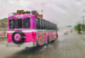 Bright pink tour bus from Xcaret near Cozumel in a rain storm.