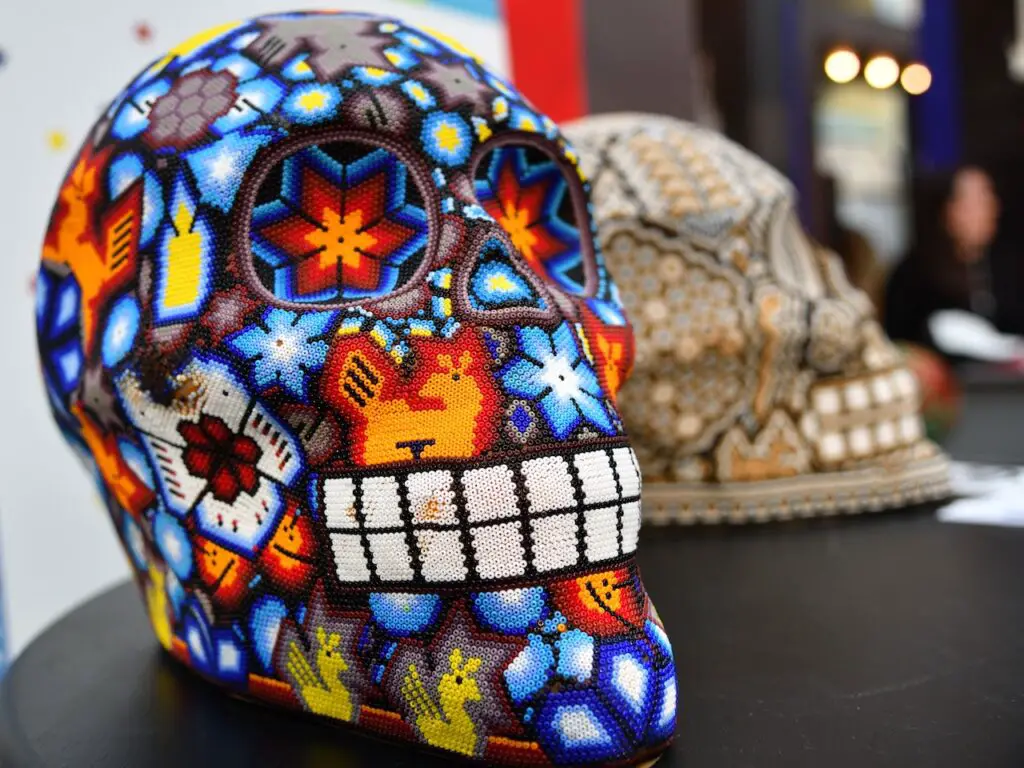 Stock photo of a colorful beaded skull in the Mexican Huichol traditional style, but with a modern flair. 