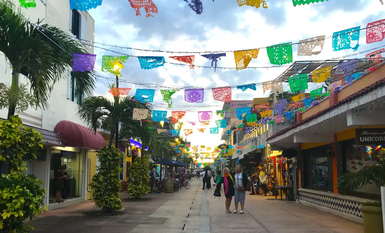 Festive paper Mexican flags adorn a popular shopping area in downtown Cozumel