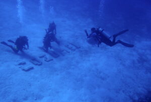 New Cozumel divers pose near a well-known cluster of bricks at Columbia reef in Cozumel. By author.