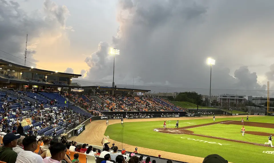 Picture from Summer 2023 of a Quintana Roo Tigres home baseball game in Cancun. Image of infield and stands along the third base line. By author. 